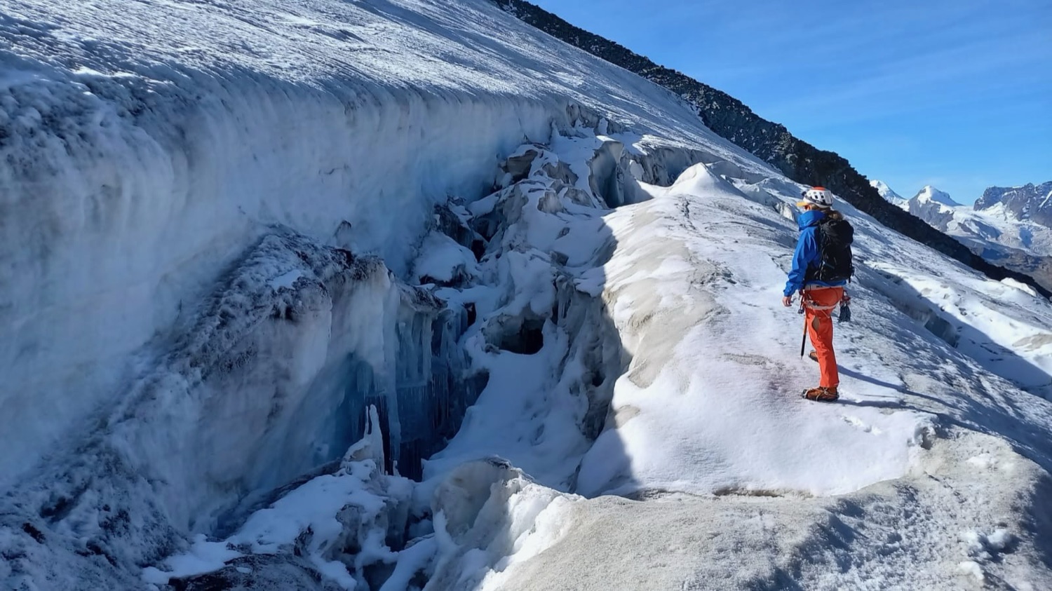 On a glacier beside a crevasse, high in the Alps
