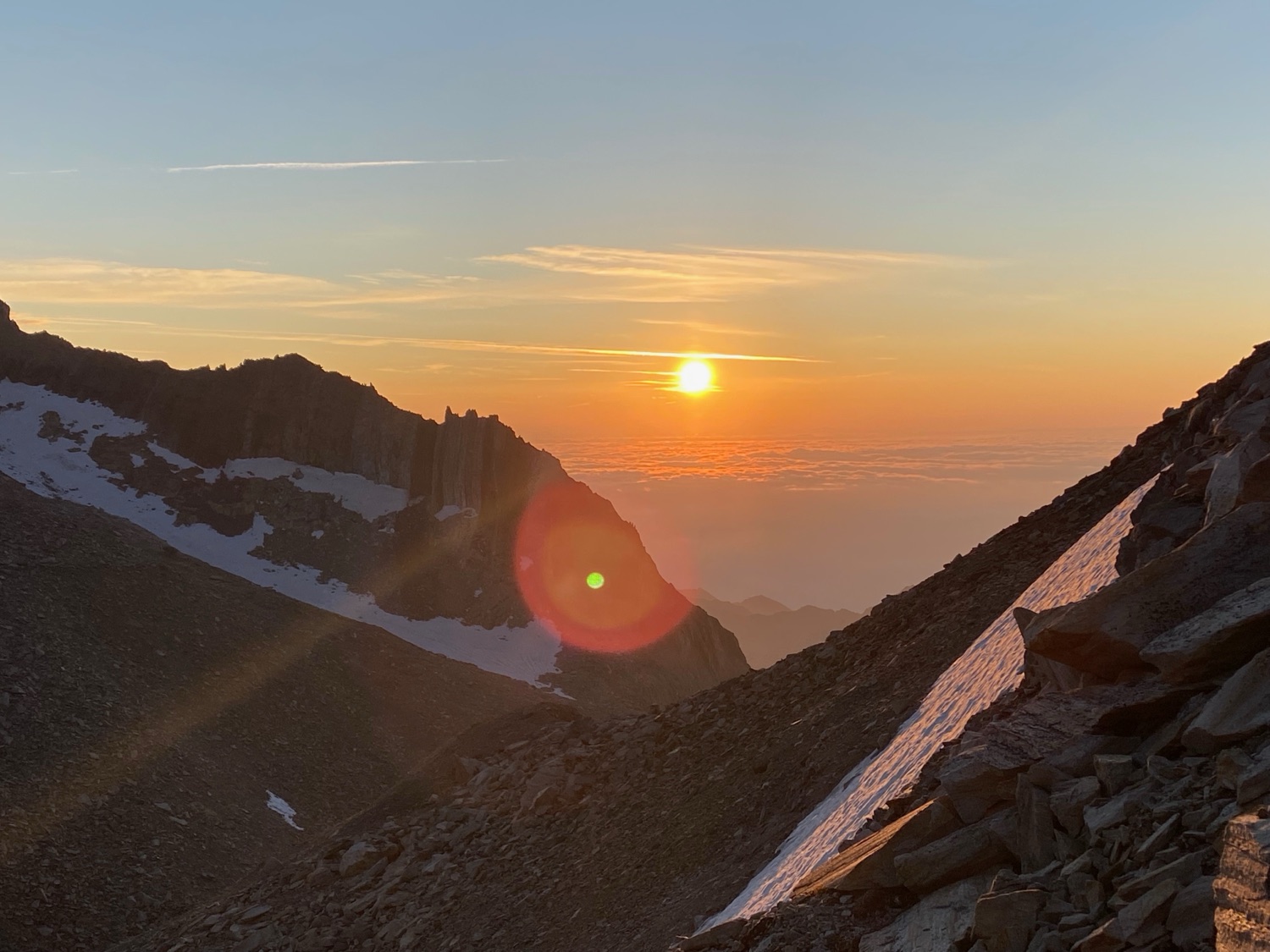 Dawn over a summit ridge, above a sea of cloud